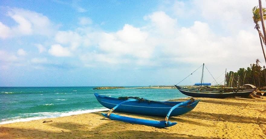 Traditional fishing boats and coastal community in Kalpitiya