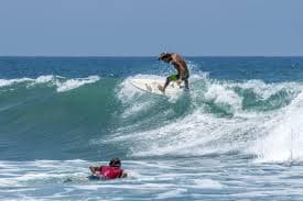 Surfer riding a wave at Arugam Bay in Sri Lanka