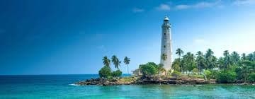 Historic lighthouse beside the ocean in Galle